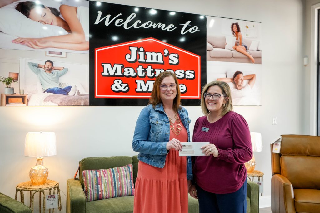 Owner, April, presenting a check to the representative of United Way of McMinn & Meigs Counties